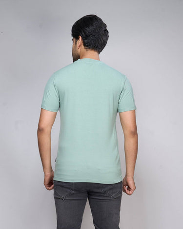 Back view of Bamboo V-Neck T-Shirt in soft green, showcasing lightweight fabric and tailored fit for sustainable everyday wear.