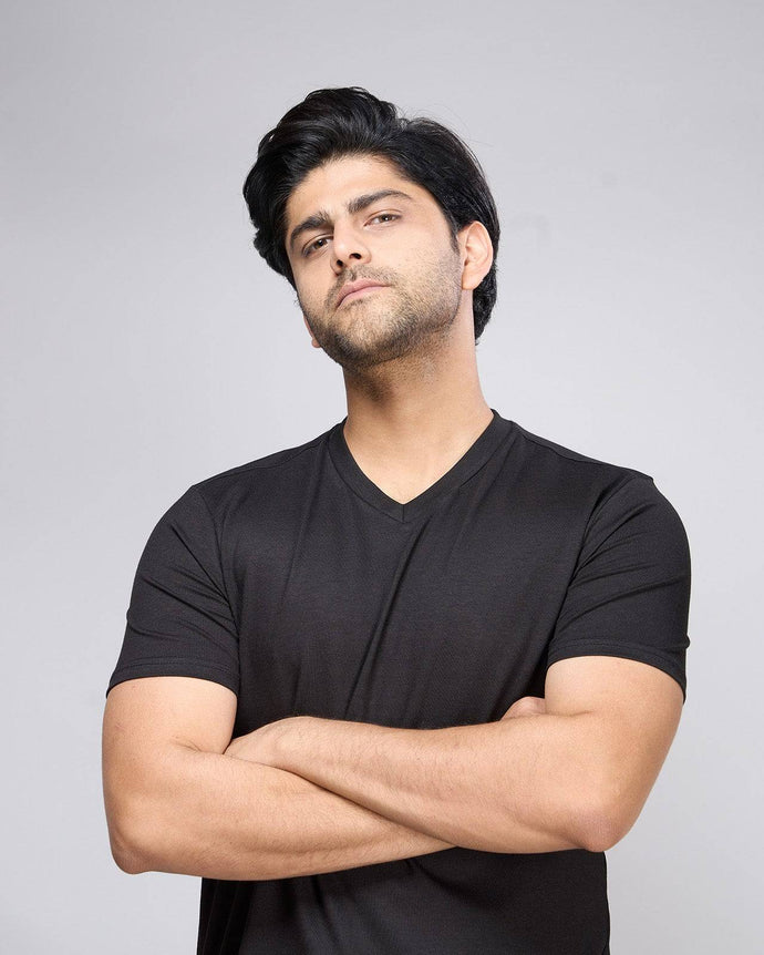 Bamboo V-Neck T-Shirt in black worn by male model with arms crossed. Soft, breathable fabric ideal for sustainable everyday wear.