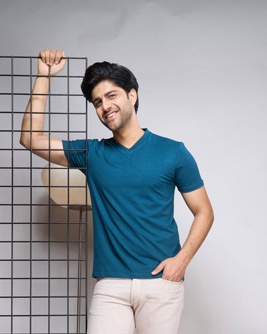 Man wearing Bamboo V-Neck T-Shirt in teal blue, showcasing soft, breathable fabric ideal for sustainable everyday wear.